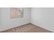 This well-lit bedroom is carpeted, has a window with blinds, and neutral wall color at 3606 Altar Rock Ln, North Las Vegas, NV 89032