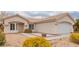 Street view of a single-story home with desert landscaping, with a front lawn of crushed gravel and small bushes at 3606 Altar Rock Ln, North Las Vegas, NV 89032