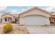 Single-story home featuring a two-car garage, desert landscaping, and a neutral color palette at 3606 Altar Rock Ln, North Las Vegas, NV 89032