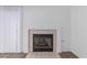 Close up of a fireplace with tile border, carpeted flooring and white walls at 3606 Altar Rock Ln, North Las Vegas, NV 89032