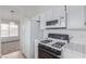 Close-up view of the kitchen appliances and tiled countertop at 3606 Altar Rock Ln, North Las Vegas, NV 89032