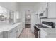 Functional kitchen with white appliances, tiled countertops, and window at 3606 Altar Rock Ln, North Las Vegas, NV 89032