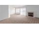 Bright living room with a fireplace, carpet flooring and plenty of natural light at 3606 Altar Rock Ln, North Las Vegas, NV 89032