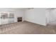 Spacious carpeted living room featuring a fireplace and sliding glass doors to the backyard at 3606 Altar Rock Ln, North Las Vegas, NV 89032
