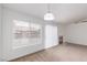 Spacious living room with large windows, fireplace, carpeted flooring, and bright white walls at 3606 Altar Rock Ln, North Las Vegas, NV 89032