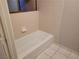 A white bathtub with tile surround is featured in the bathroom at 3621 Laguna Verde Way, Las Vegas, NV 89121