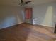 Bedroom featuring wood floors and a single window at 3621 Laguna Verde Way, Las Vegas, NV 89121