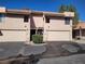 Beige two-story townhome with a two-car garage and a red tile roof, located on a sunny lot at 3621 Laguna Verde Way, Las Vegas, NV 89121
