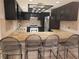 Kitchen featuring a granite countertop with barstool seating and stainless steel appliances at 3621 Laguna Verde Way, Las Vegas, NV 89121