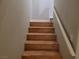 A wooden staircase with a white railing provides access to the upper level of the home at 3621 Laguna Verde Way, Las Vegas, NV 89121