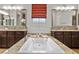 Bright bathroom featuring a large soaking tub, granite counters, and wood cabinets at 4169 San Capri Way, Las Vegas, NV 89141