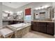 Spacious bathroom with a large soaking tub, granite counters, and wood cabinets at 4169 San Capri Way, Las Vegas, NV 89141