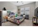 Cozy bedroom featuring carpet floors, two chairs, and plentiful natural light from two windows at 4169 San Capri Way, Las Vegas, NV 89141