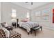 Comfortable bedroom featuring modern decor, two windows with white shutters, and sitting area at 4169 San Capri Way, Las Vegas, NV 89141