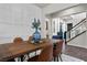 Elegant dining space with a wooden table, stylish seating, and access to the staircase at 4169 San Capri Way, Las Vegas, NV 89141