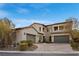 Attractive two-story home featuring a three-car garage, well-maintained landscape, and a circular driveway at 4169 San Capri Way, Las Vegas, NV 89141