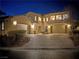 Beautiful two-story home with a stone facade, two-car garage, and illuminated exterior at 4169 San Capri Way, Las Vegas, NV 89141