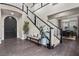 Elegant foyer featuring dark wood floors, a staircase, and access to the dining area at 4169 San Capri Way, Las Vegas, NV 89141