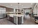 Open concept with island, stainless appliances, granite countertops, and seamless flow into the living space at 4169 San Capri Way, Las Vegas, NV 89141