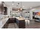 Bright kitchen featuring an island with granite countertops and seamless access to the living room and backyard at 4169 San Capri Way, Las Vegas, NV 89141