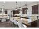 Spacious kitchen with dark wood cabinetry, granite countertops, and a large island with seating at 4169 San Capri Way, Las Vegas, NV 89141