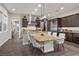 Spacious eat-in kitchen featuring dark wood cabinetry, granite countertops, and stainless steel appliances at 4169 San Capri Way, Las Vegas, NV 89141