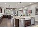 Open floorplan with a kitchen island, granite counters, and access to the living area and outdoor space at 4169 San Capri Way, Las Vegas, NV 89141
