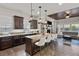 Open concept kitchen and living room with a large island, fireplace and hardwood floors at 4169 San Capri Way, Las Vegas, NV 89141