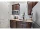 Kitchenette complete with granite countertops, stainless steel refrigerator, and subway tile backsplash at 4169 San Capri Way, Las Vegas, NV 89141
