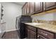 Convenient laundry room featuring stylish countertops, ample cabinet space, and modern appliances at 4169 San Capri Way, Las Vegas, NV 89141