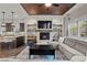 Cozy living area showcasing a fireplace, hardwood flooring, and seamless transition to the kitchen at 4169 San Capri Way, Las Vegas, NV 89141