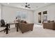 Spacious living room with neutral decor, ceiling fan, and outdoor views from a balcony at 4169 San Capri Way, Las Vegas, NV 89141