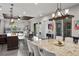 Open-concept living room with large windows, hardwood floors, and a modern lighting fixture at 4169 San Capri Way, Las Vegas, NV 89141