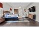 A bright main bedroom with dark wood floors, modern decor, and a barn door entry at 4169 San Capri Way, Las Vegas, NV 89141