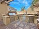 Fully equipped outdoor kitchen features a built-in grill, stainless steel appliances, and ample counter space at 4169 San Capri Way, Las Vegas, NV 89141