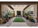 Outdoor patio with brick pavers, string lights, lush plants, and seating area for relaxation and entertaining at 4169 San Capri Way, Las Vegas, NV 89141