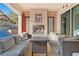 Cozy outdoor patio with a fireplace, comfortable seating, and access to the sparkling pool at 4169 San Capri Way, Las Vegas, NV 89141