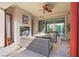 Relaxing outdoor patio featuring a fireplace, comfortable seating, and access to the backyard at 4169 San Capri Way, Las Vegas, NV 89141