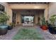 Cozy outdoor patio with pavers, artificial turf, potted plants, and covered seating at 4169 San Capri Way, Las Vegas, NV 89141