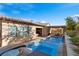 Inviting backyard with a luxurious pool, waterfall feature, and comfortable lounge area for ultimate relaxation at 4169 San Capri Way, Las Vegas, NV 89141