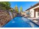 Beautiful pool area showcases a waterfall feature with stone accents and well-manicured landscaping at 4169 San Capri Way, Las Vegas, NV 89141