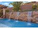 Beautiful backyard pool featuring a stone waterfall feature in a desert landscaped setting at 4169 San Capri Way, Las Vegas, NV 89141