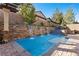 This stunning pool features a cascading waterfall and mature landscaping, offering a serene retreat at 4169 San Capri Way, Las Vegas, NV 89141