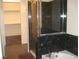 Luxurious bathroom featuring marble countertops, tub, and glass-enclosed shower at 50 E Serene Ave # 321, Las Vegas, NV 89123