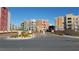 Manhattan Condominiums community entrance with colorful buildings, manicured landscaping, and well maintained driveways at 50 E Serene Ave # 321, Las Vegas, NV 89123