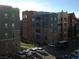 Exterior view of multi-story building with multiple cars parked in front at 50 E Serene Ave # 321, Las Vegas, NV 89123