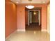Well-maintained building hallway featuring tile flooring, warm lighting, and neutral paint at 50 E Serene Ave # 321, Las Vegas, NV 89123
