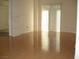 Bright living room with hardwood floors and sliding glass doors to a private balcony at 50 E Serene Ave # 321, Las Vegas, NV 89123