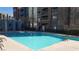 Inviting community pool area with clear blue water, lounge chairs, and manicured landscaping at 50 E Serene Ave # 321, Las Vegas, NV 89123
