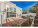 Secluded backyard with gravel landscaping and a large glass window on the home at 5077 Thunder River Cir, Las Vegas, NV 89148
